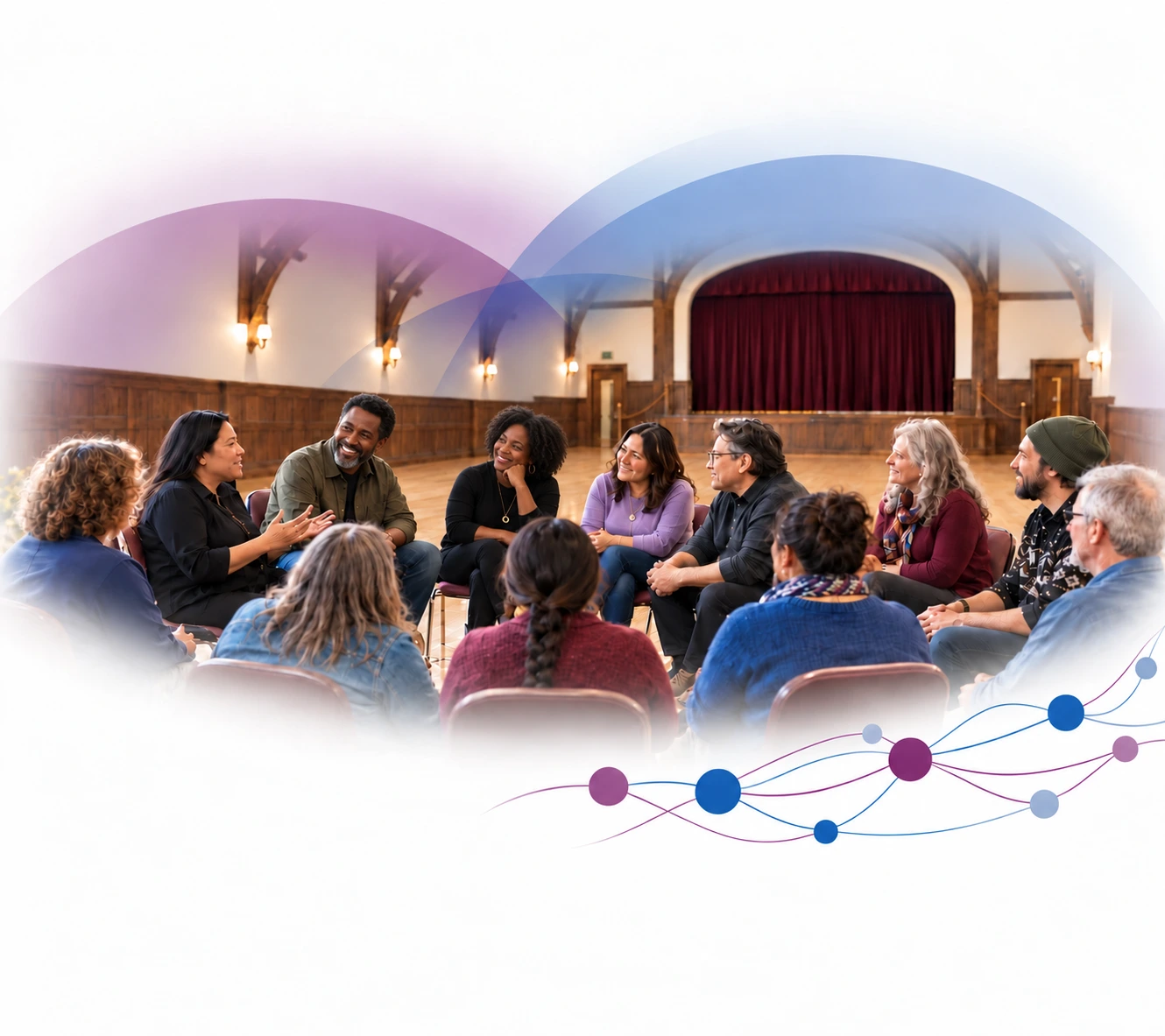 People sharing a conversation in a circle of chairs in a historic hall.